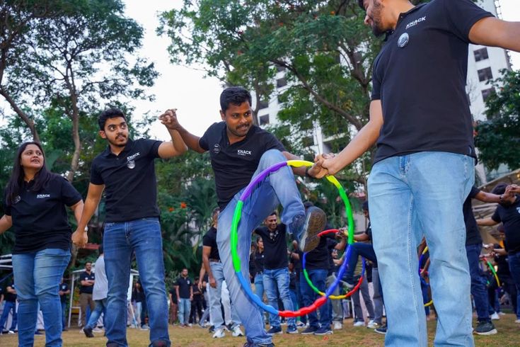 Colleagues supporting each other during an outdoor team challenge