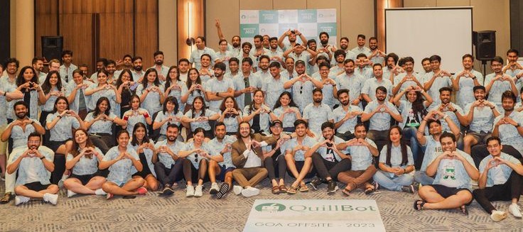Company offsite group portrait in a conference hall