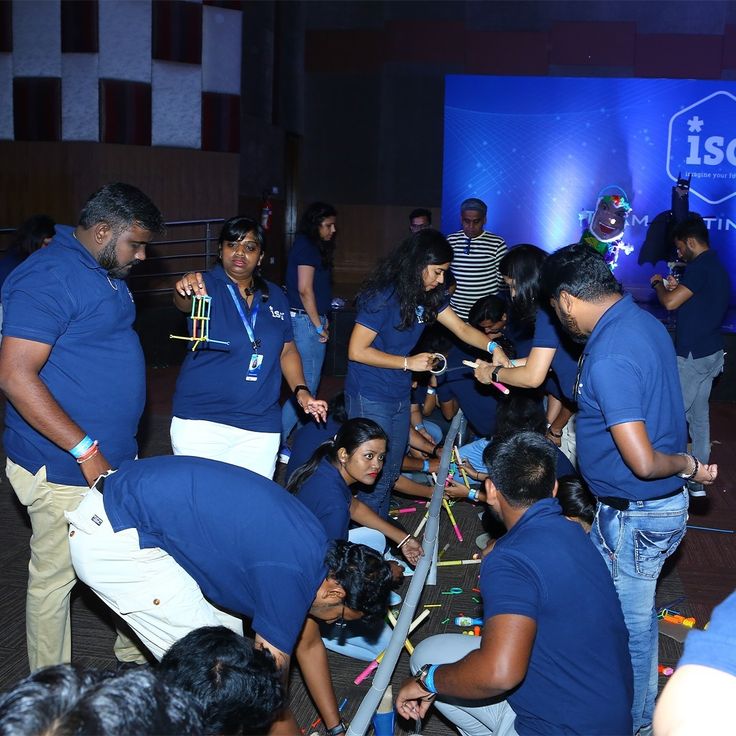 Hands-on team building under blue stage lighting
