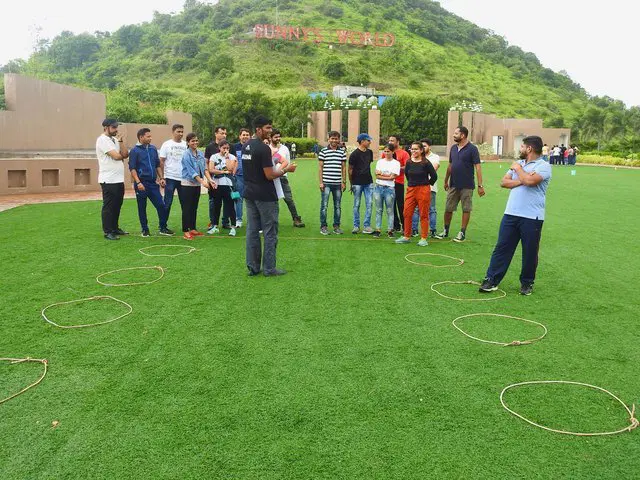 Corporate team engaged in a structured outdoor team building experience organised by Showmaker